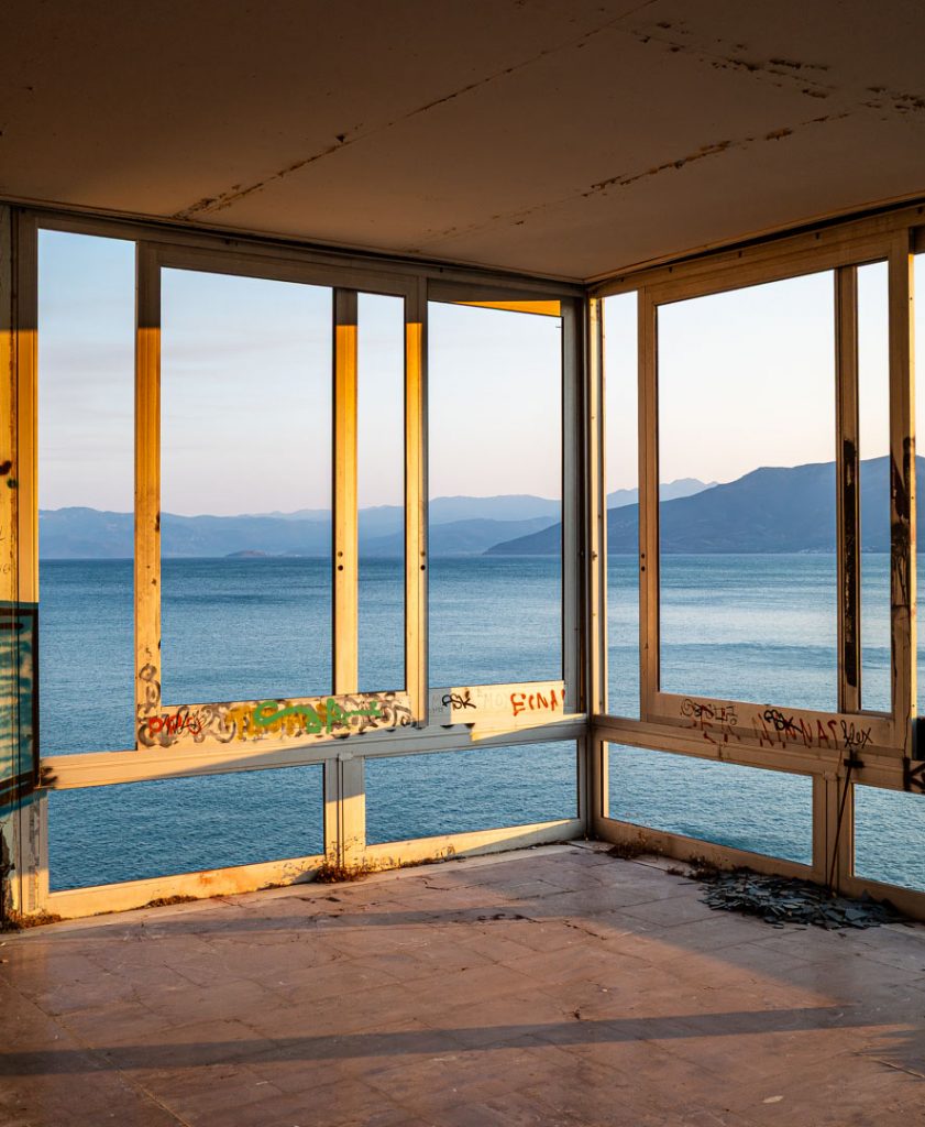 Abandoned room with wide windows facing the sea