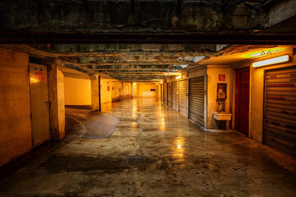 Garage interior with orange shutters and warm light reflected on the floor