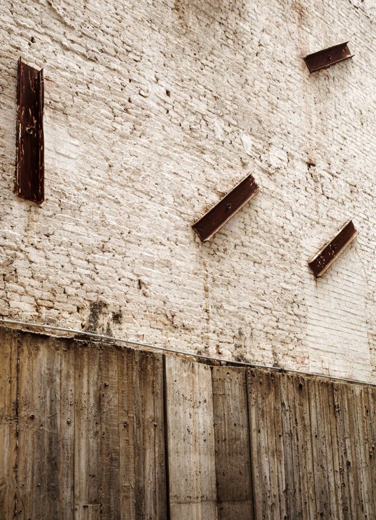 Concrete wall with protruding rusted metal beams