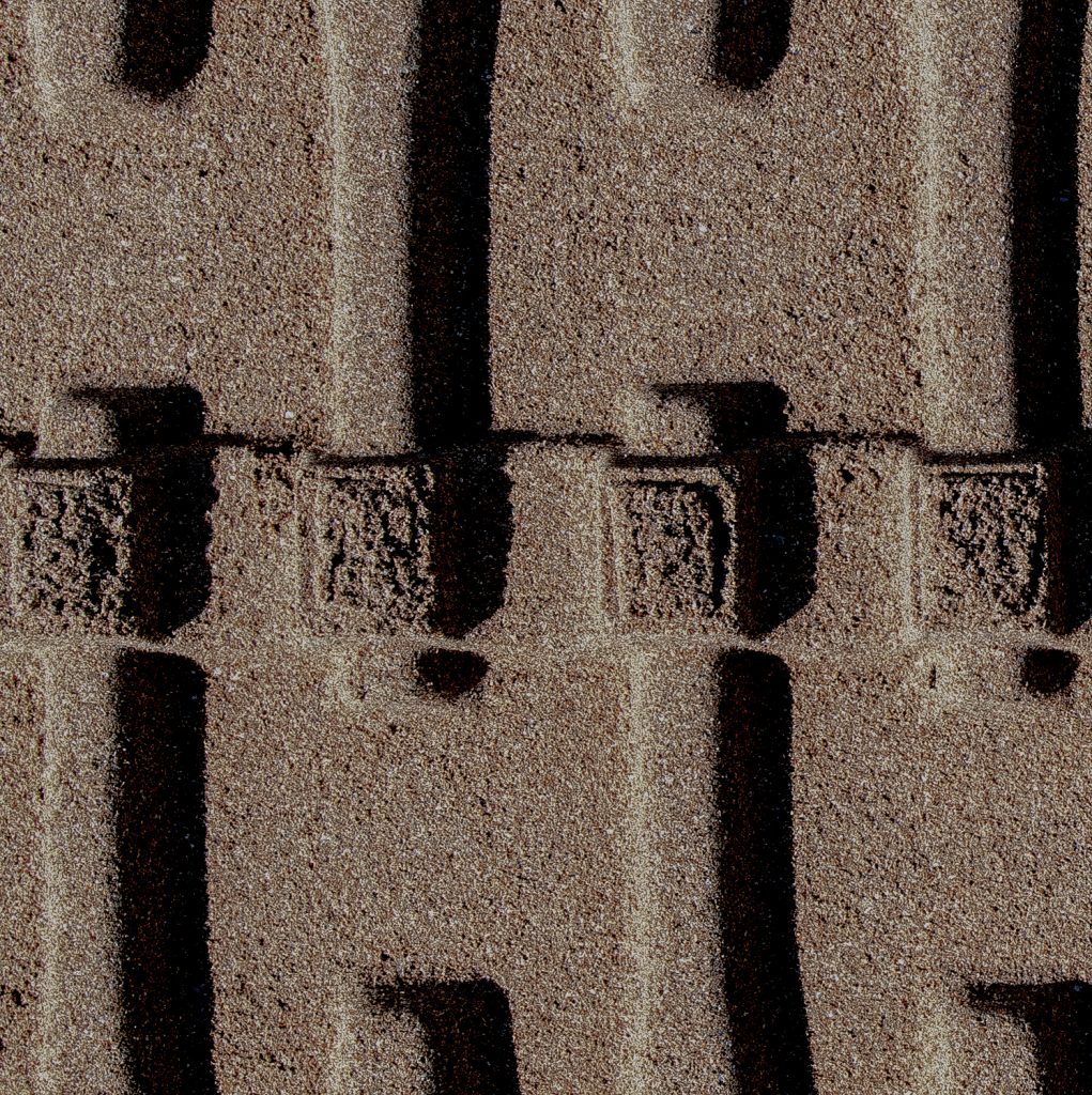 Stone surface with regular rectangular recesses, shot flat