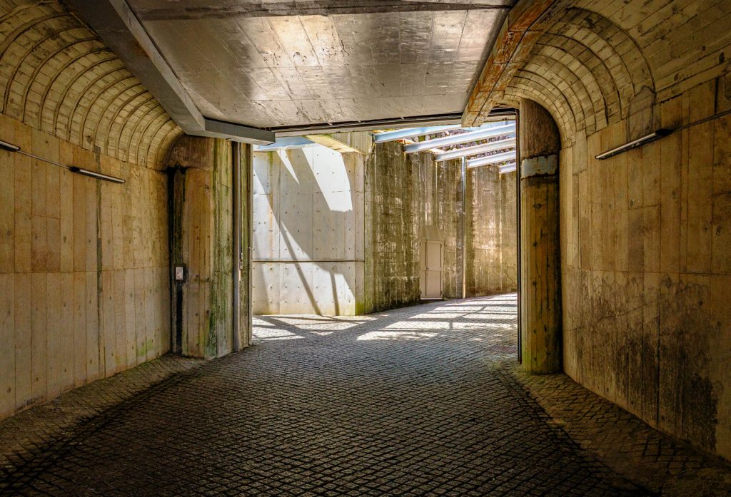 Vaulted stone underpass with light entering from the far end